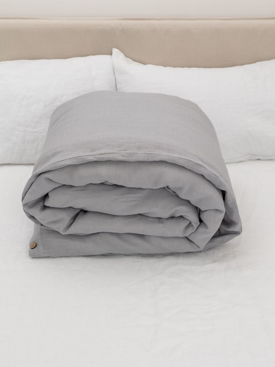 100% flax linen Moonlit Grey duvet cover rolled on bed – OEKO-TEX Standard 100, cozy & compact