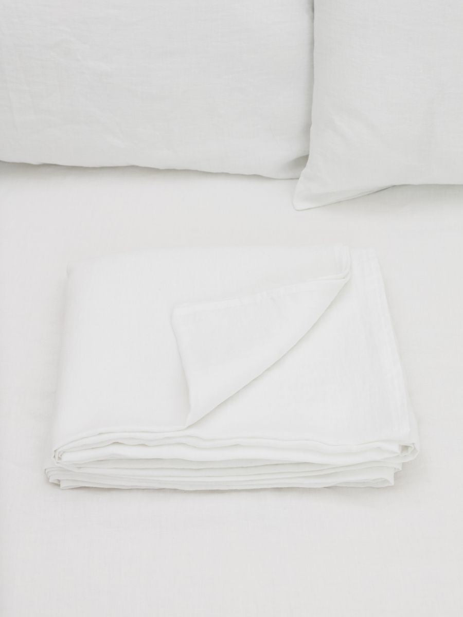 100% flax linen Magnolia White flat sheet folded with corner turned – crisp, luxurious feel